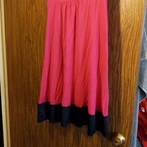 A beautiful pink dress, with black trim.